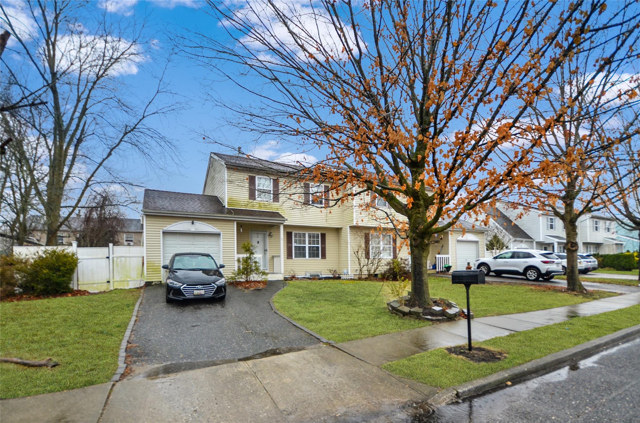 a car parked in front of brick house with a yard