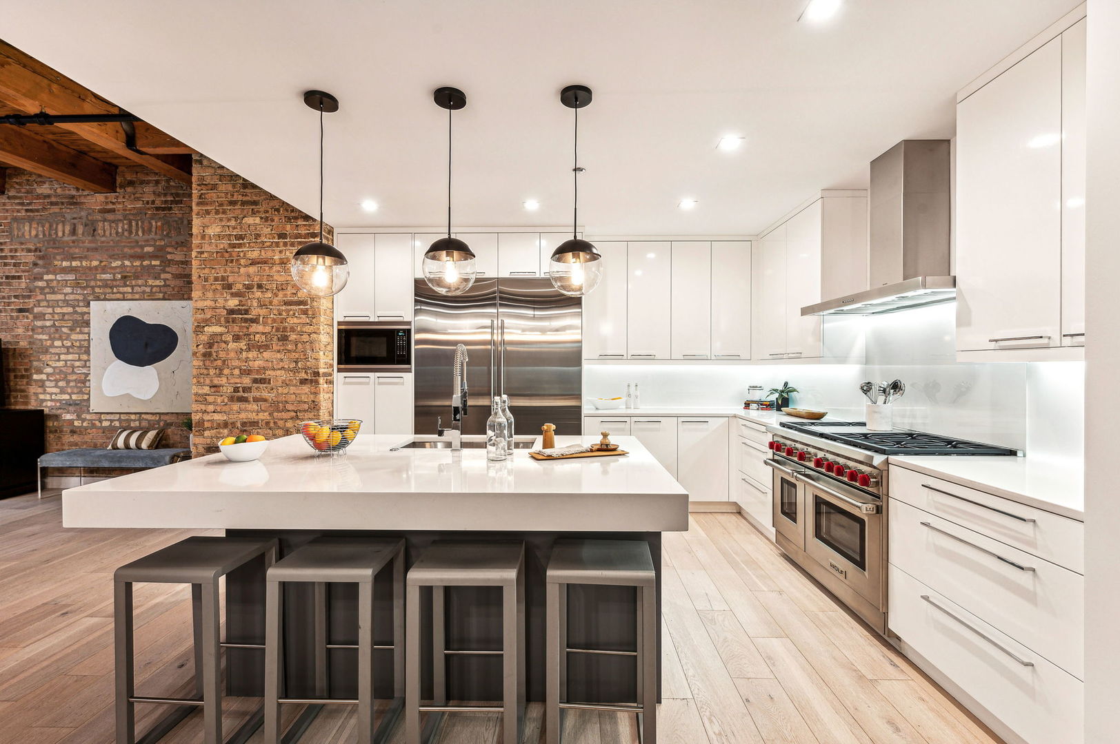 223 West Lake Street, Unit PH5S Chicago, IL 60606 - Photo 13 of 32 a kitchen with stainless steel appliances kitchen island granite countertop a sink a stove and a wooden floors