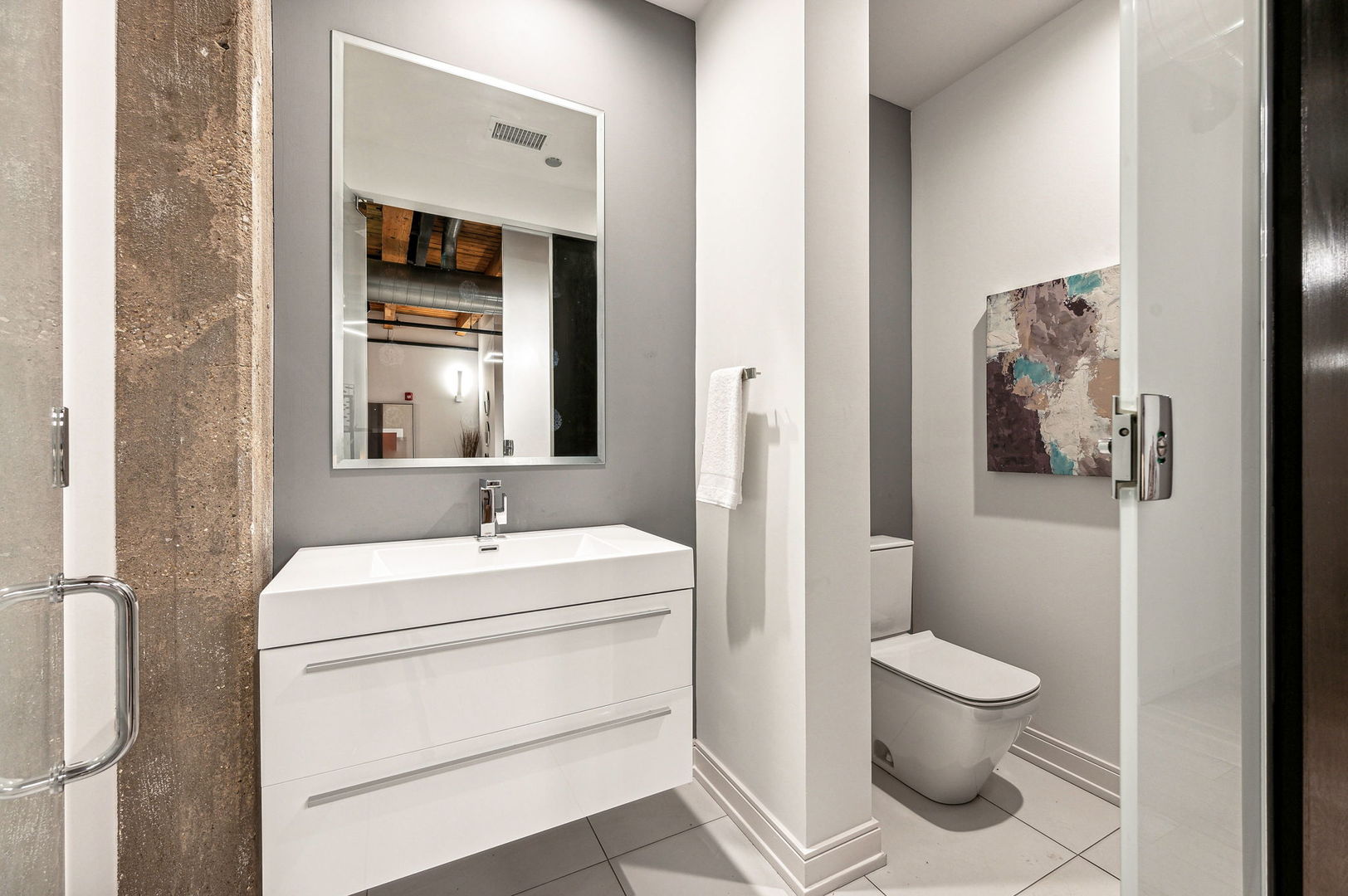 223 West Lake Street, Unit PH5S Chicago, IL 60606 - Photo 16 of 32 a bathroom with a toilet sink and mirror