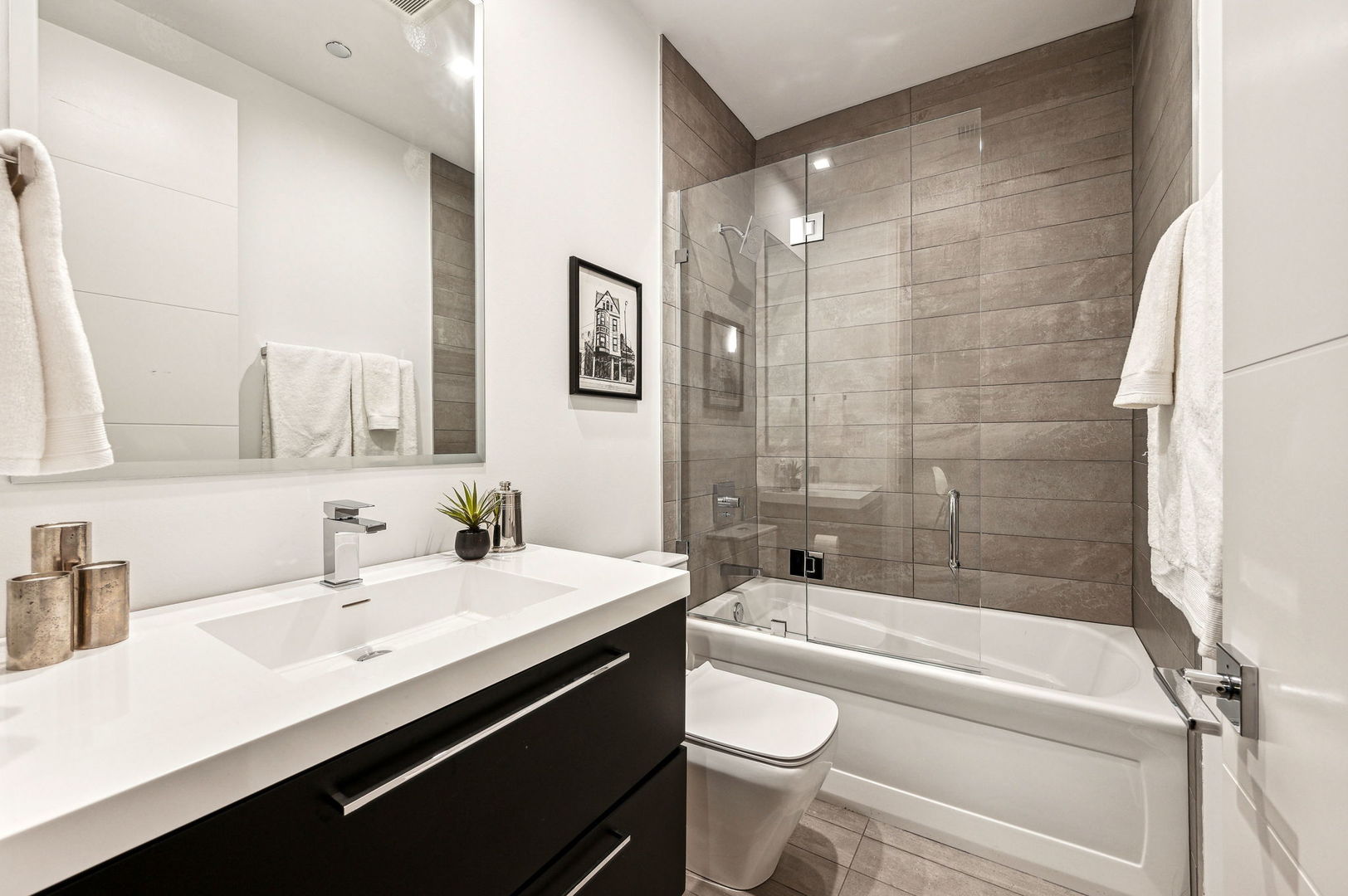 223 West Lake Street, Unit PH5S Chicago, IL 60606 - Photo 27 of 32 a bathroom with a bathtub shower sink vanity mirror and toilet