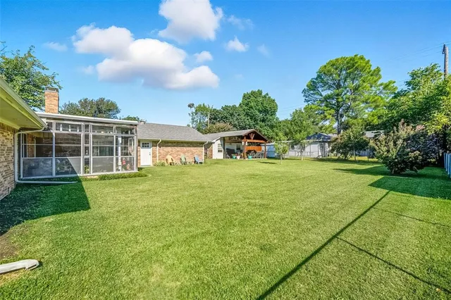 a view of an house with backyard space and garden