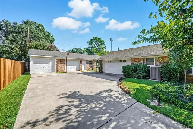 a front view of a house with a yard and a garage