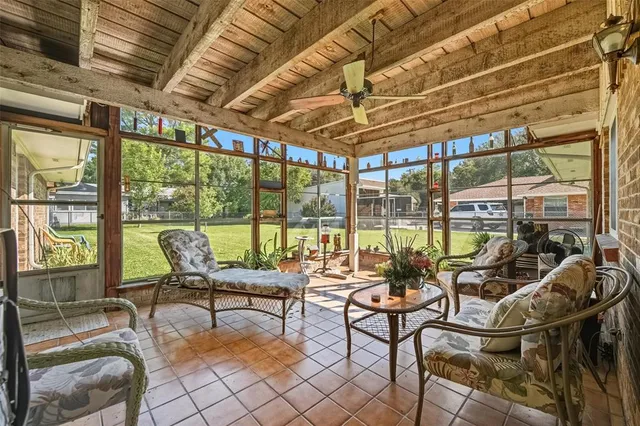 a living room with furniture and floor to ceiling windows