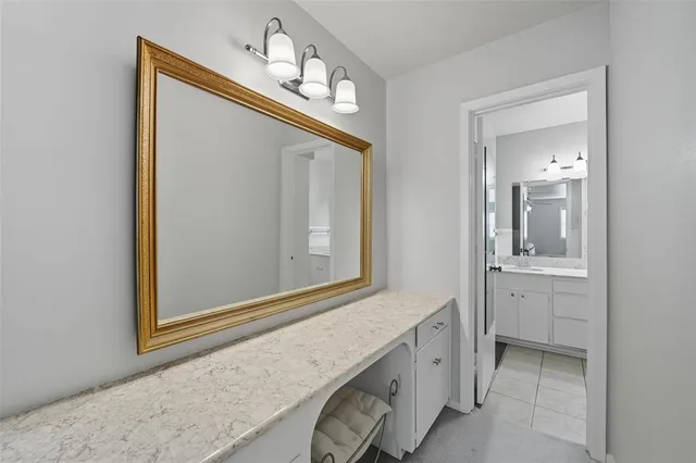 a bathroom with a sink a mirror and a vanity