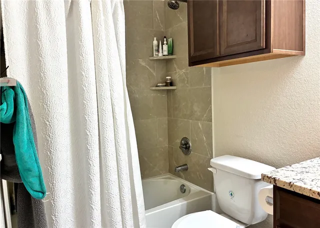 a bathroom with a granite countertop sink a vanity and mirror