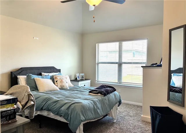 a bedroom with a bed and a bookshelf