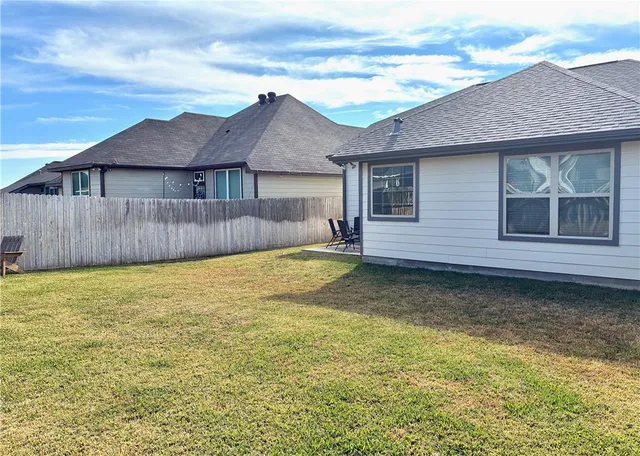 a view of a patio with table and chairs under an umbrella
