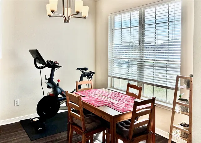 a view of a dining room with furniture and window