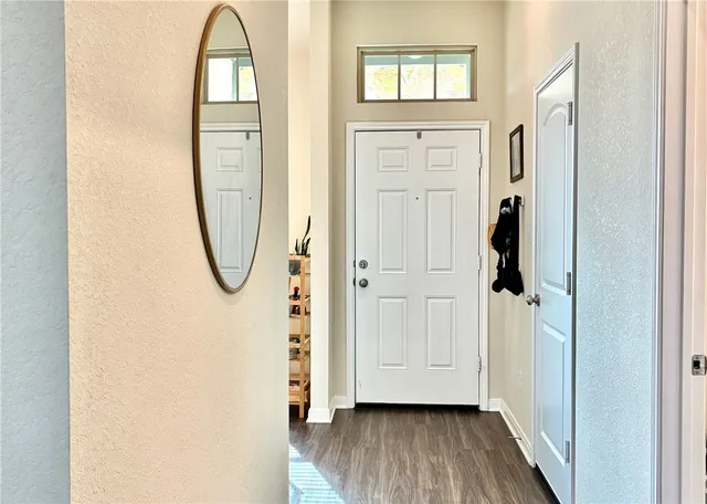 a view of a livingroom with wooden floor and a white door