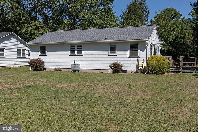 a living room with furniture a flat screen tv and a large window