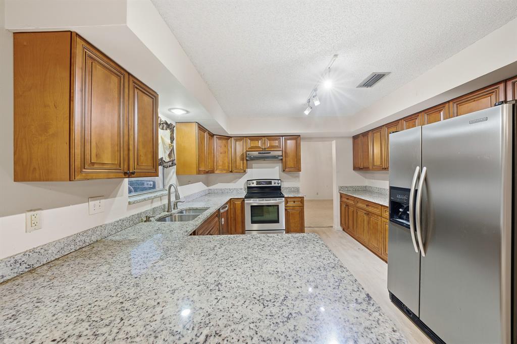 3091 Venice Way Miramar, FL 33025 - Photo 11 of 27 a kitchen with stainless steel appliances granite countertop a refrigerator a oven a sink with island and chairs