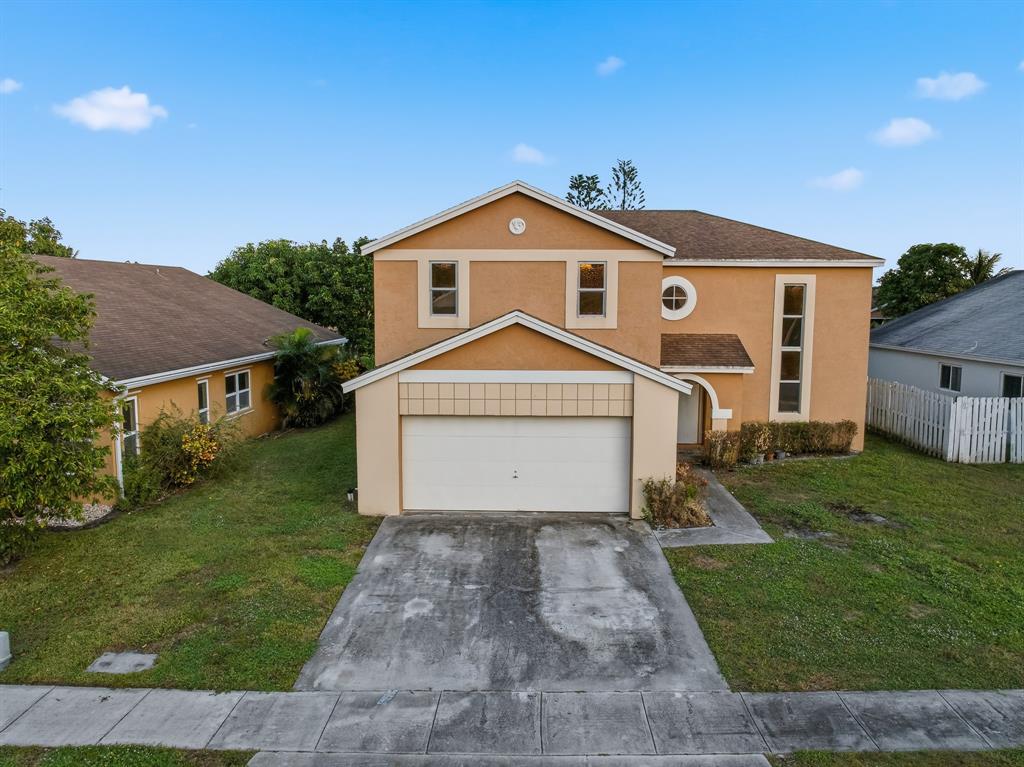 3091 Venice Way Miramar, FL 33025 - Photo 2 of 27 a front view of a house with a yard and garage