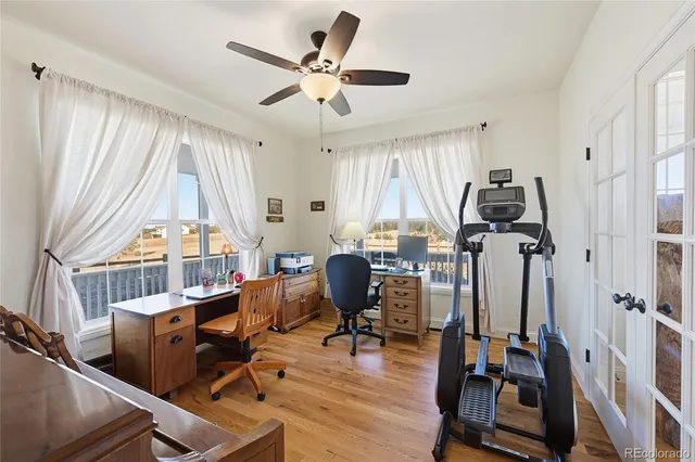 a view of a workspace with furniture and a window
