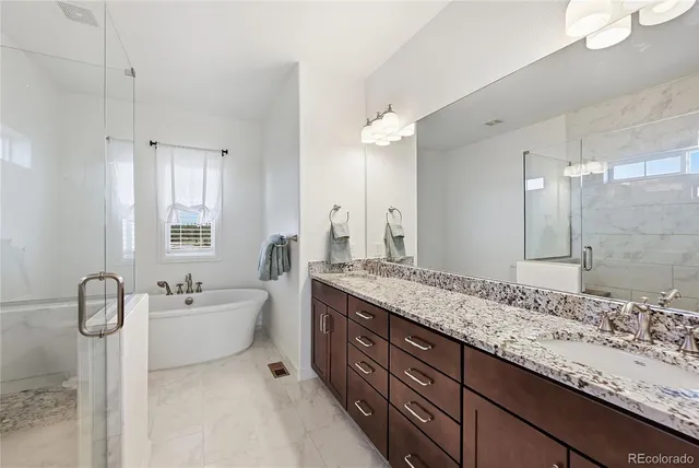 a spacious bathroom with a granite countertop sink mirror and double