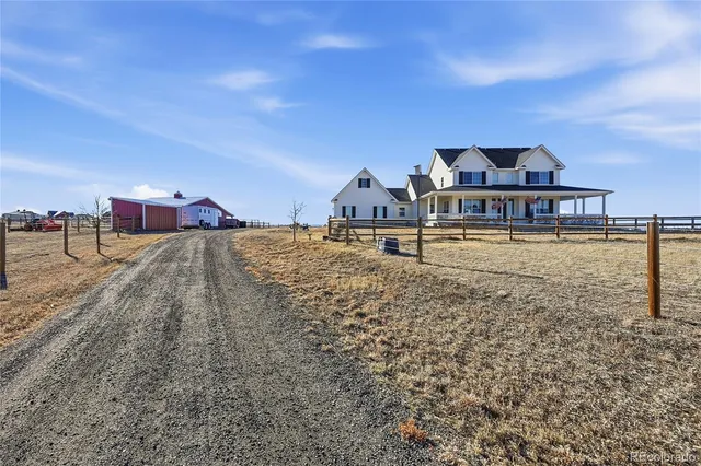 a view of house with yard and ocean view