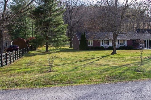 a house view with a swimming pool and wooden fence