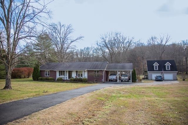 a view of a brick house with a swimming pool
