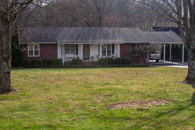 a front view of house with a garden