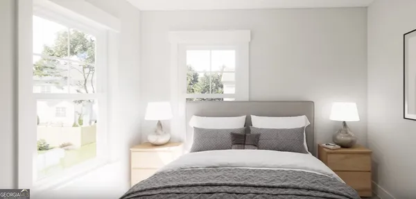 a bedroom with a bed and a large window