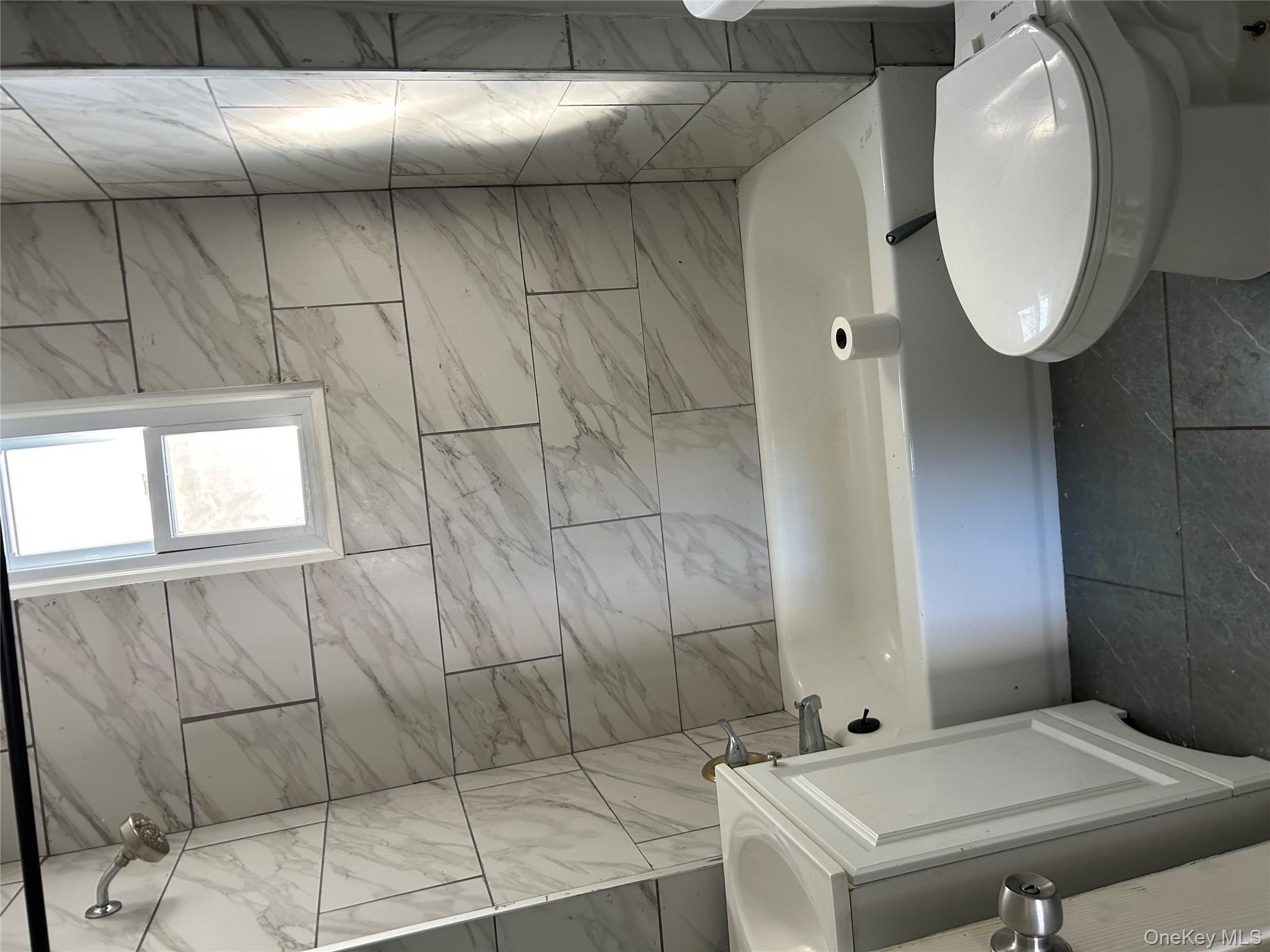 1 Gray Street Poughkeepsie, NY 12603 - Photo 9 of 22 a bathroom with a white toilet and bathtub