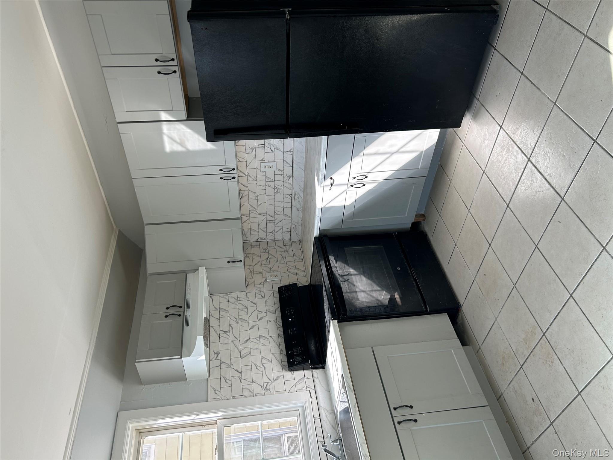 1 Gray Street Poughkeepsie, NY 12603 - Photo 10 of 22 a kitchen with a refrigerator sink and cabinets