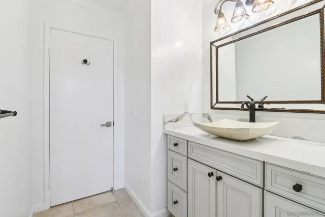 a view of bathroom with a sink and mirror