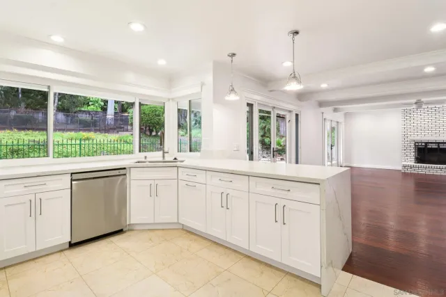 a large white kitchen with a large window