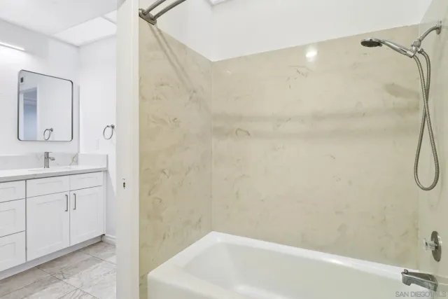 a bathroom with a sink a mirror and a bathtub