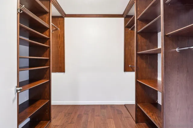 a view of walk in closet with empty racks