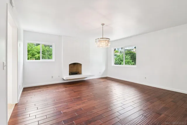 a view of a room with wooden floor and window