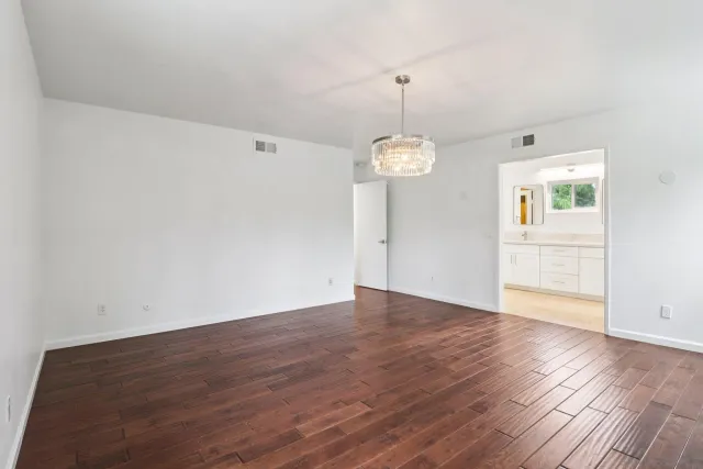 a spacious bathroom with a double vanity sink and a mirror