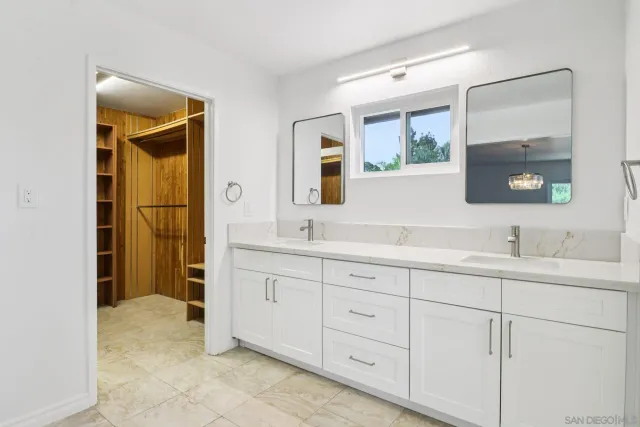 a white toilet sitting next to a bathroom sink