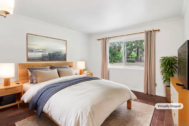 a bedroom with bed and a potted plant