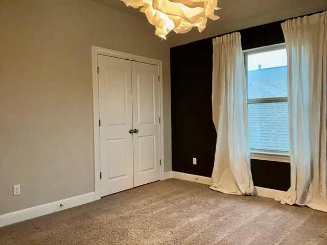 a view of an empty room with a fireplace