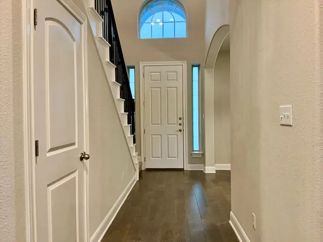 a view of a livingroom with wooden floor and stair