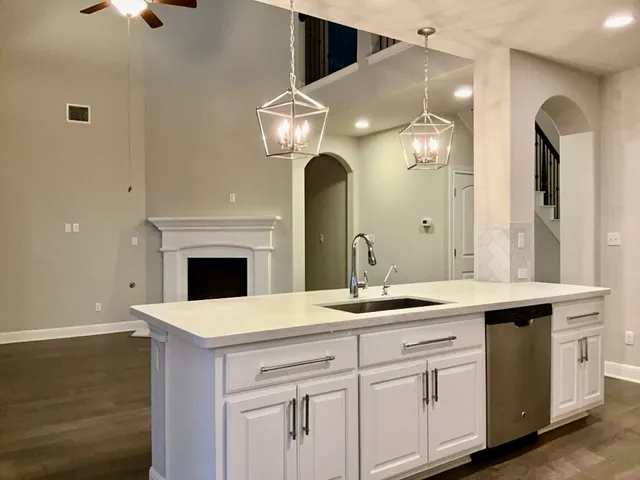a kitchen with a sink and a fireplace