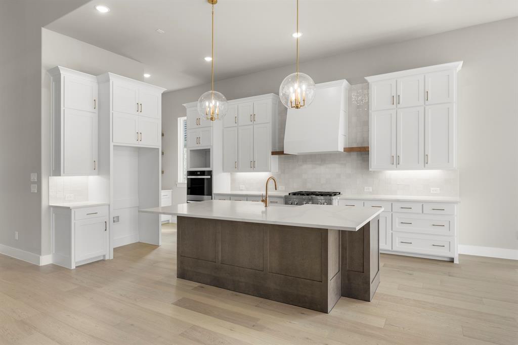 4512 Meander Way Prosper, TX 75078 - Photo 12 of 39 a kitchen with a sink stove and cabinets