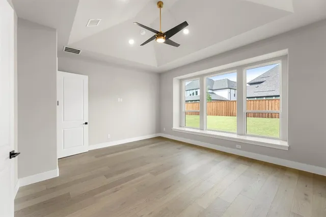 a view of a livingroom with a ceiling fan and wooden floor
