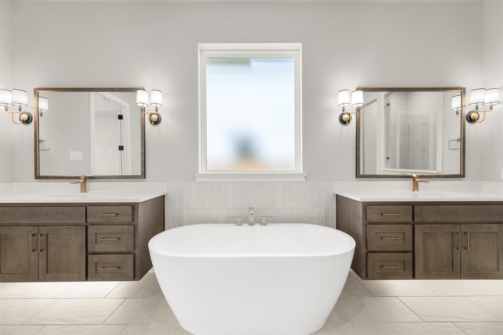 4512 Meander Way Prosper, TX 75078 - Photo 16 of 39 a spacious bathroom with a tub sink and mirror