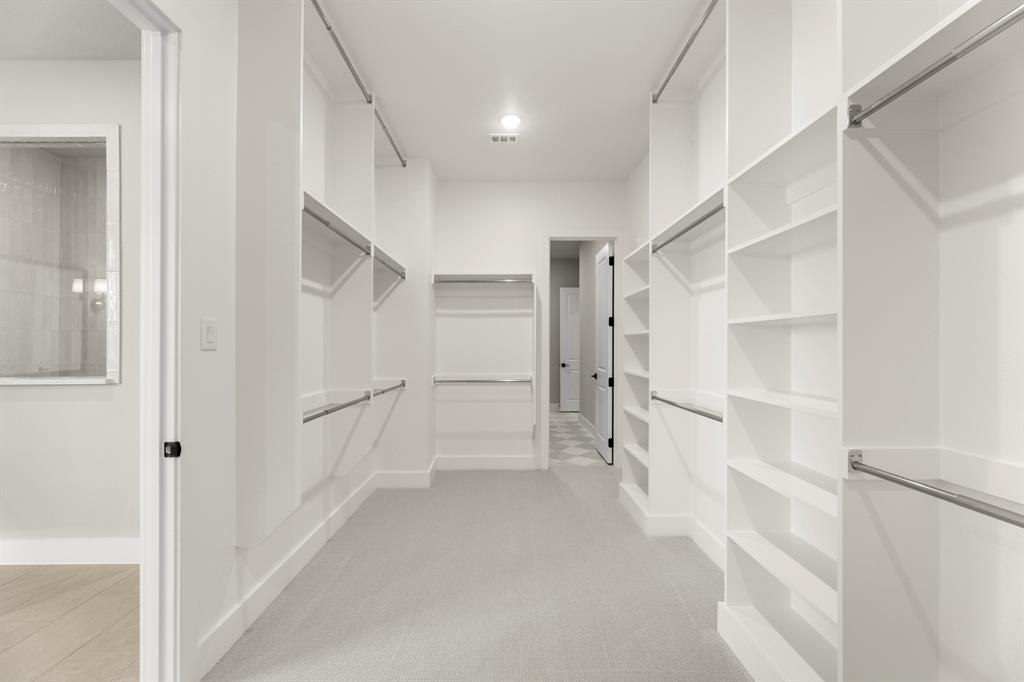 4512 Meander Way Prosper, TX 75078 - Photo 19 of 39 a view of walk in closet with empty racks