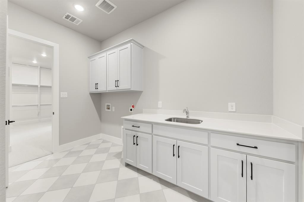 4512 Meander Way Prosper, TX 75078 - Photo 22 of 39 a room with a sink and cabinets