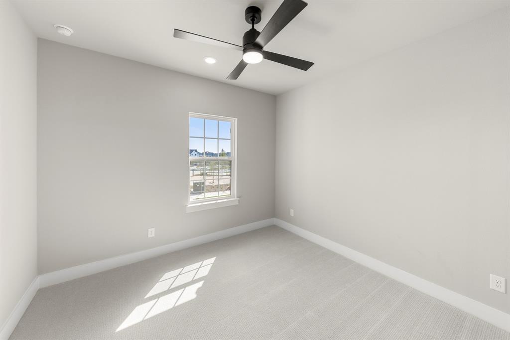 4512 Meander Way Prosper, TX 75078 - Photo 25 of 39 an empty room with a window and a fan