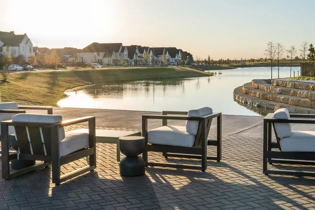 a view of a lake from balcony with outdoor seating