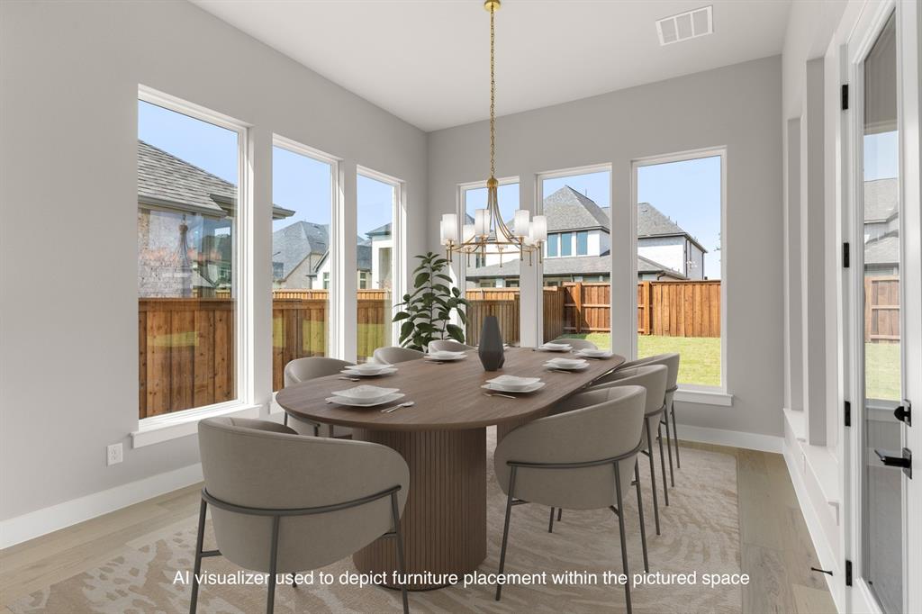 4512 Meander Way Prosper, TX 75078 - Photo 5 of 39 a dining room with furniture a chandelier and wooden floor