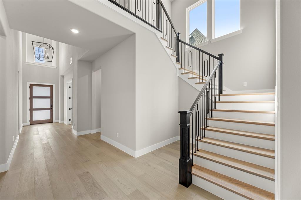 4512 Meander Way Prosper, TX 75078 - Photo 7 of 39 a view of entryway with wooden floor