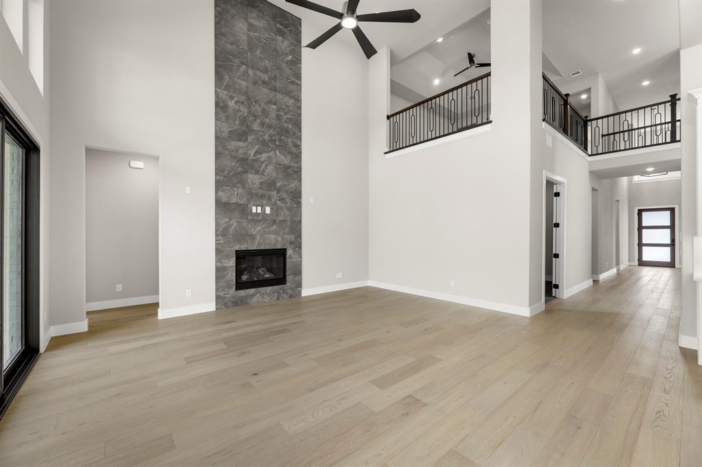 4512 Meander Way Prosper, TX 75078 - Photo 9 of 39 a view of a livingroom with a fireplace and cabinet