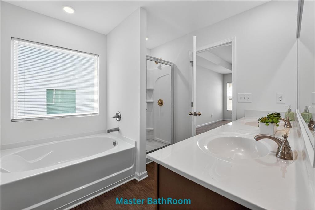233 Bloomfield Circle Canton, GA 30114 - Photo 13 of 22 a bathroom with a bathtub and a sink