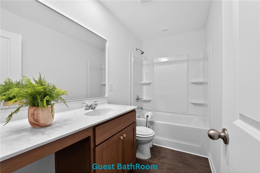 233 Bloomfield Circle Canton, GA 30114 - Photo 19 of 22 a bathroom with a sink a toilet a tub and shower