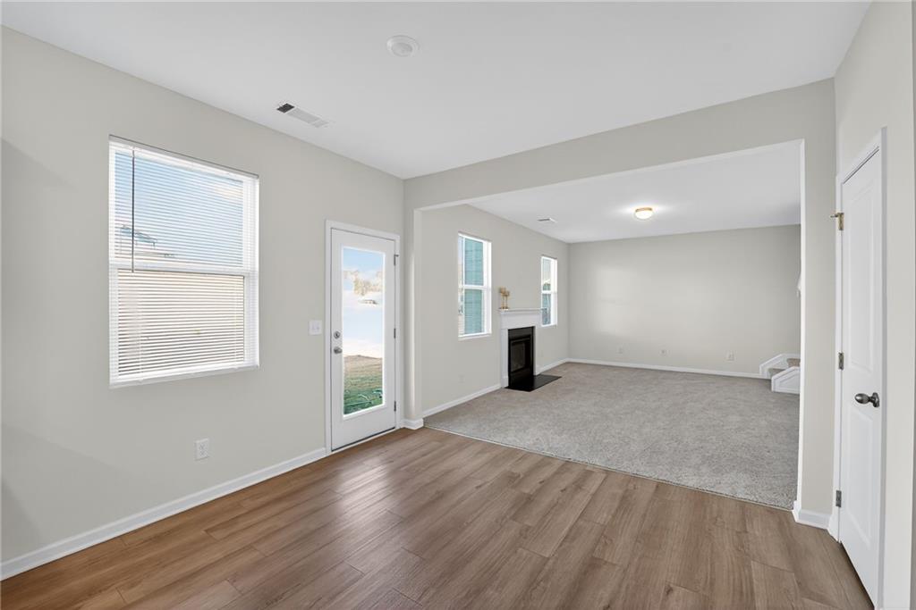 233 Bloomfield Circle Canton, GA 30114 - Photo 6 of 22 a view of an empty room with wooden floor and a window