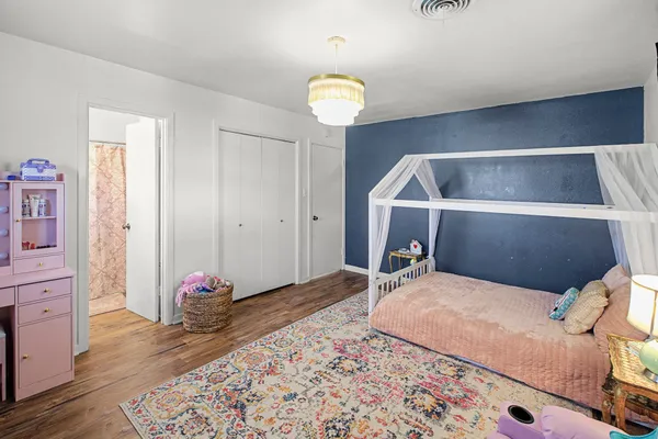 a bedroom with a bed and a chandelier